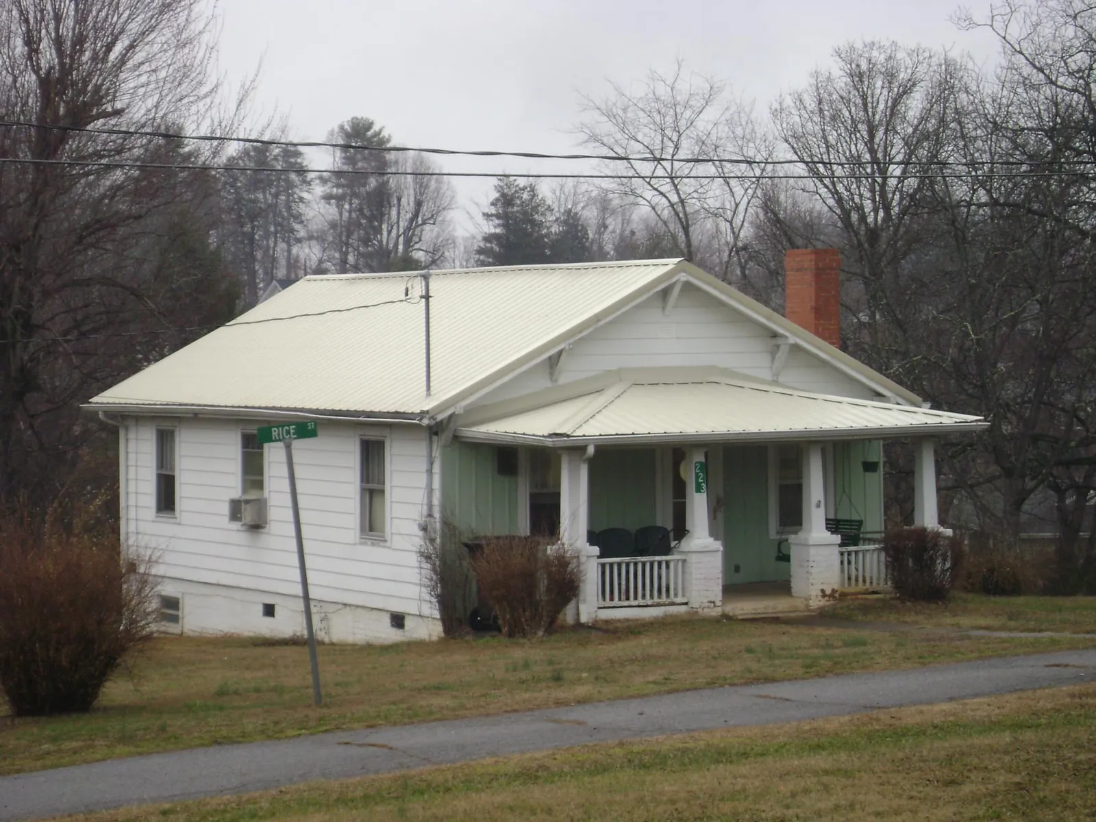 White metal roof on a craftsman bungalow at a street corner in Garden Prairie